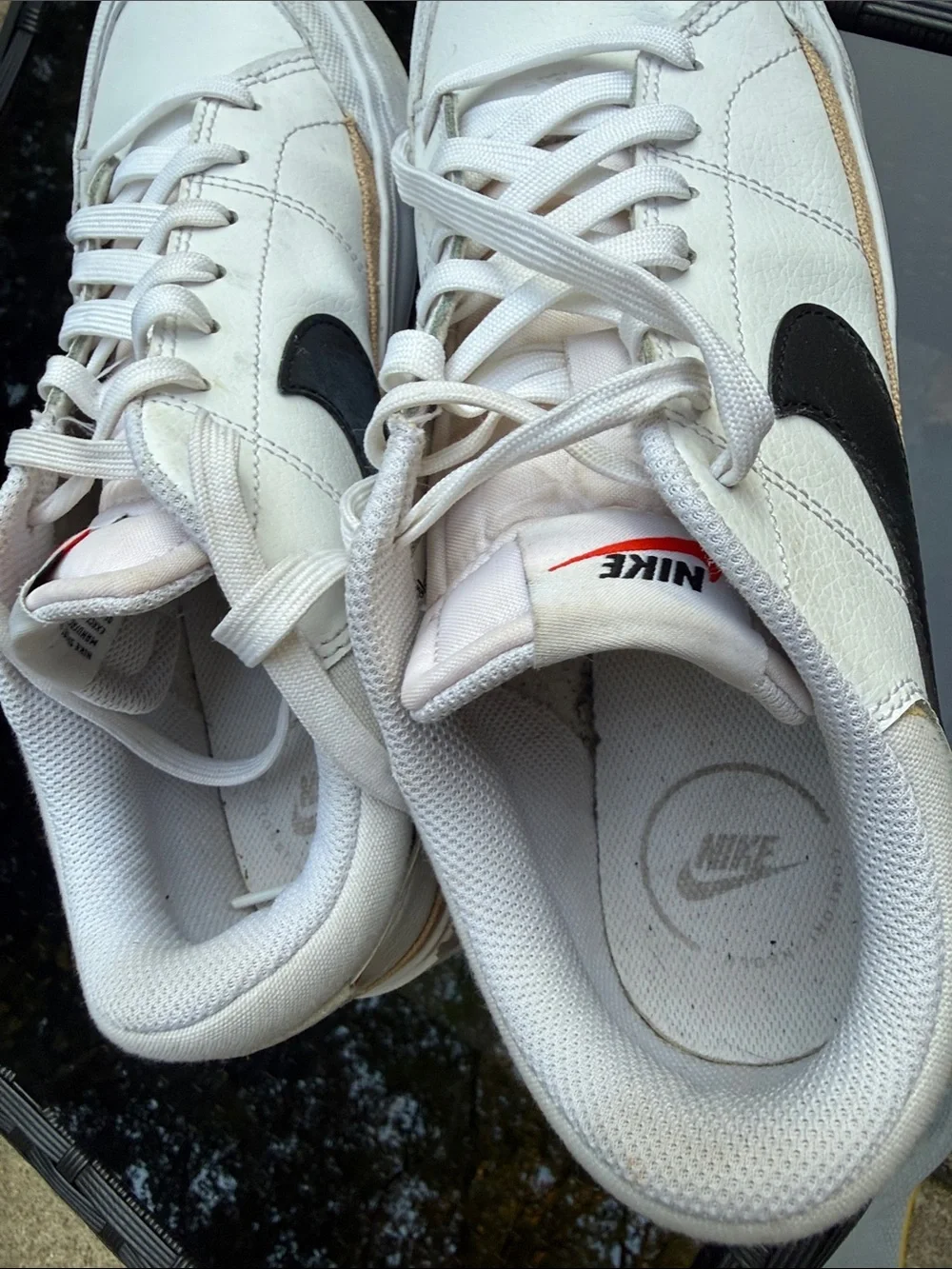 Nike White Sneakers with Black Swoosh and Small Red Logo